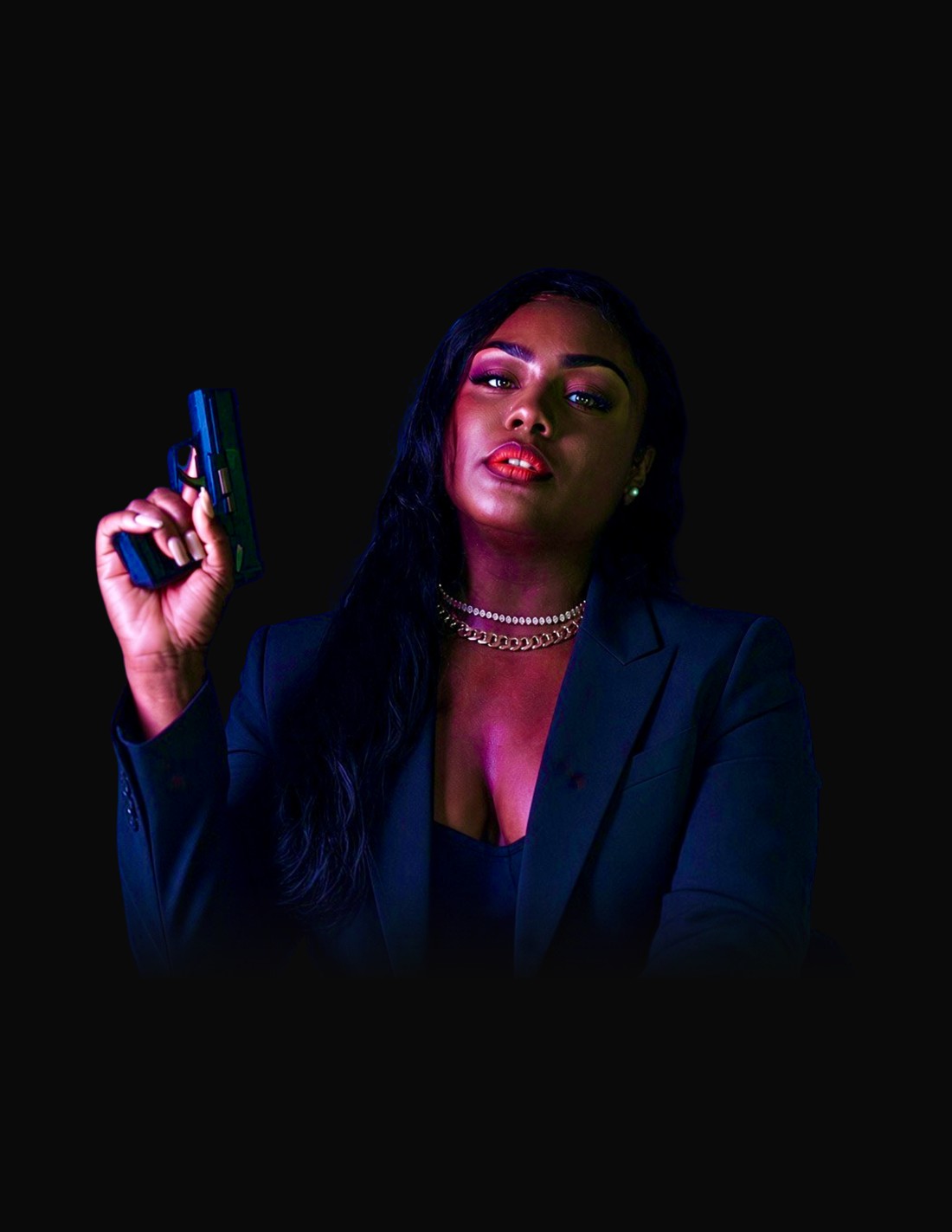 Confident woman in a black suit holding a training pistol